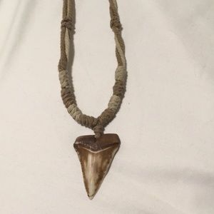 Shark tooth Hawaiian necklace with adjustable yarn pull.